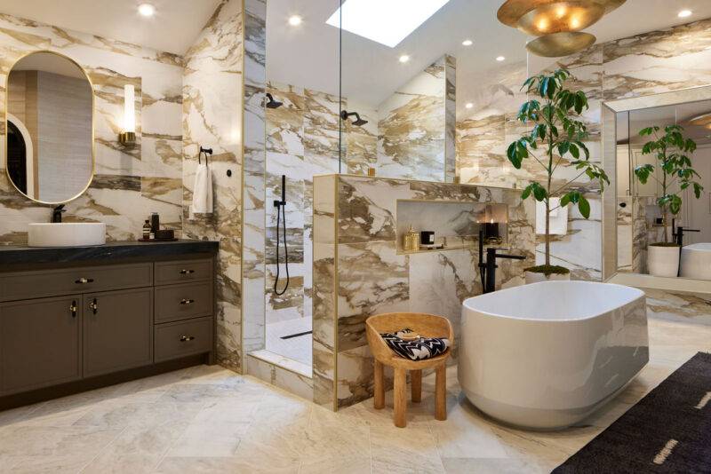 Bathroom wall adorned with dramatic brown and ochre veined marble-look tiles.