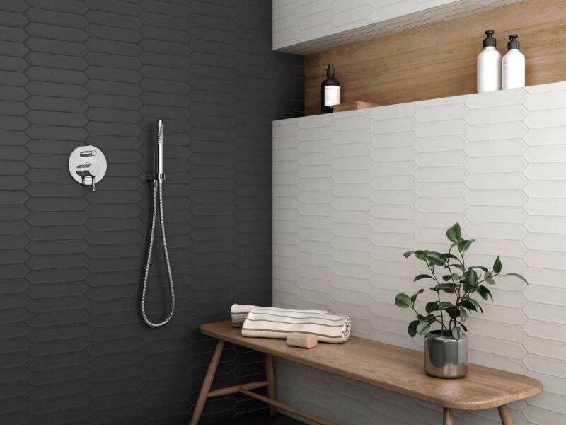 Shower featuring black and white picket tiles arranged horizontally for a modern twist.