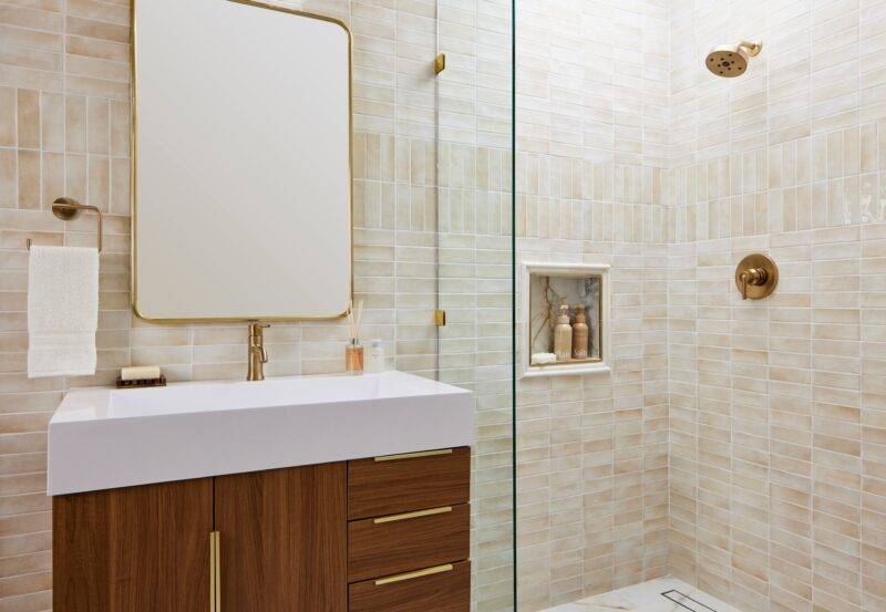 Bathroom wall showcasing a mix of matte and glossy beige tiles for added depth.