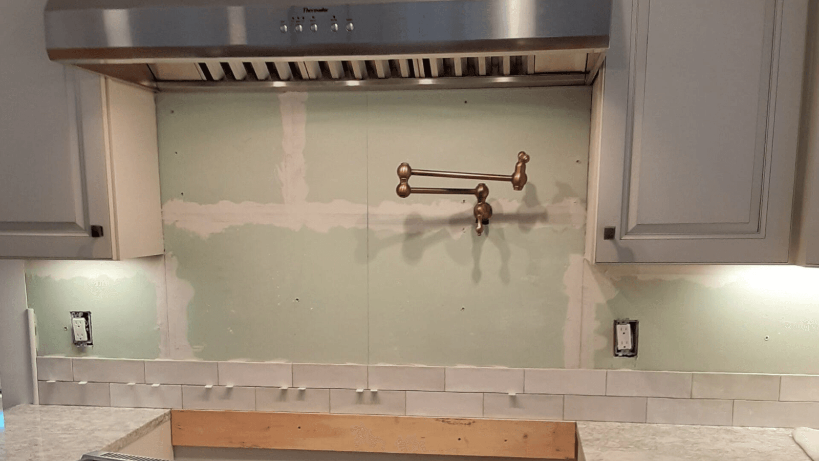 Ceramic white subway tile backsplash before