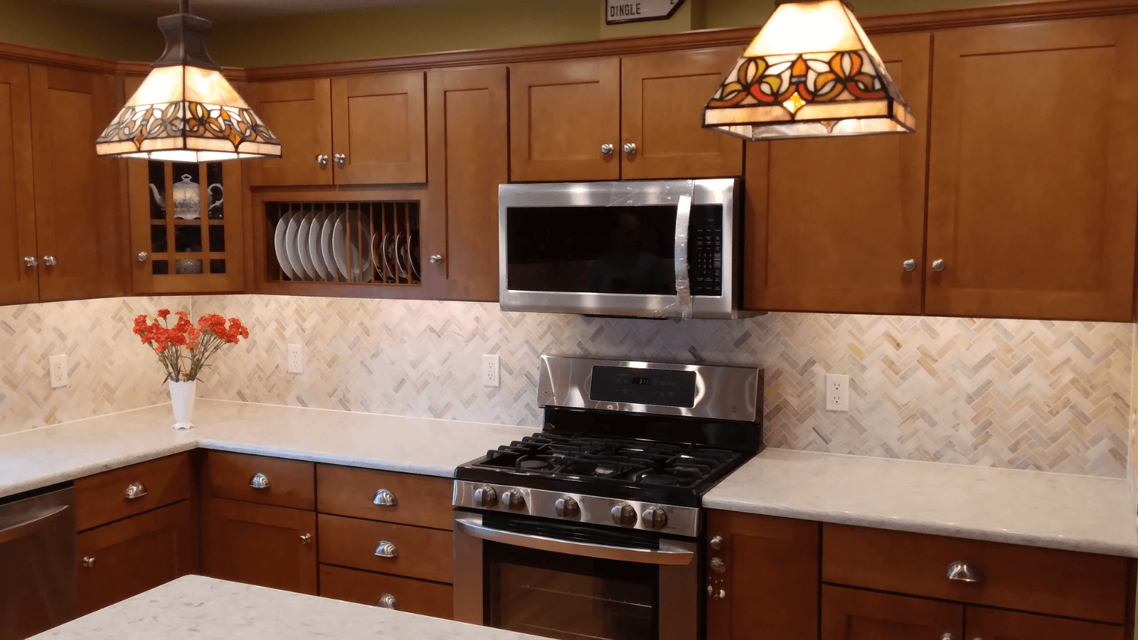 Marble tile herringbone backsplash after
