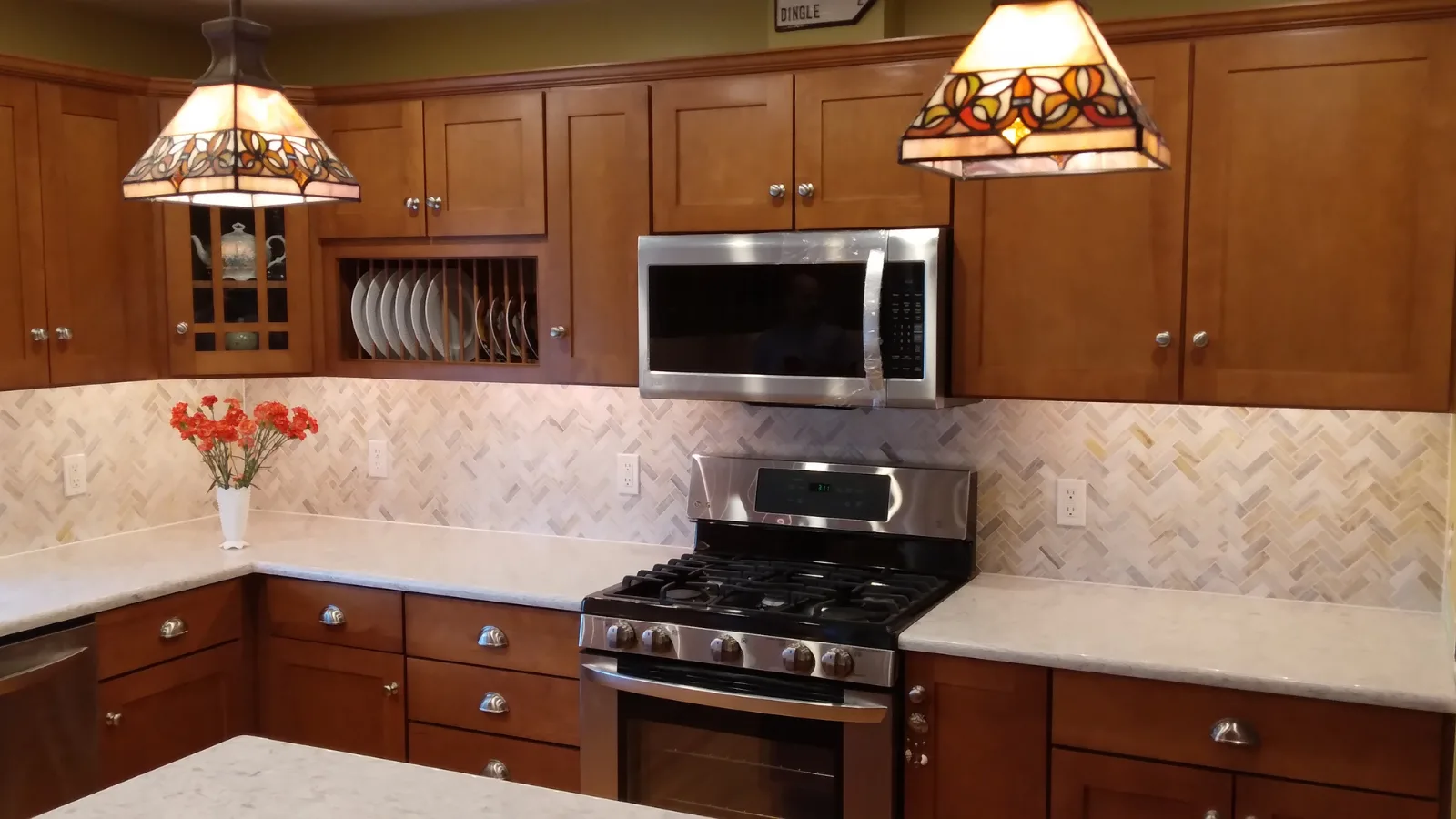 Marble tile herringbone backsplash after