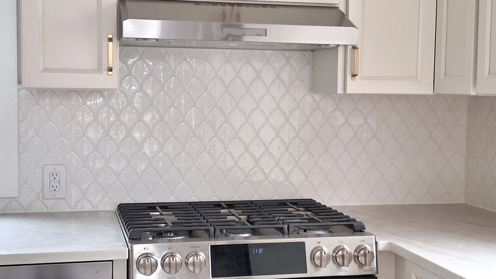 Scallop white porcelain tile backsplash after