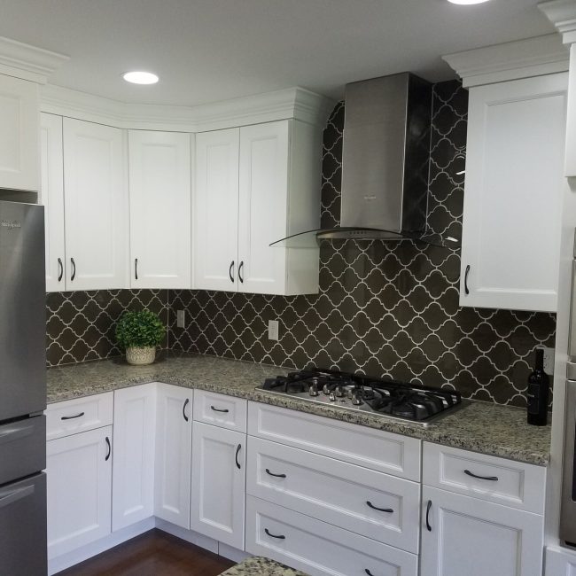 Glossy Glass Arabesque Tile Backsplash Glass arabesque tile backsplash with a glossy finish in a bright, stylish kitchen