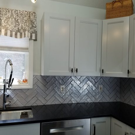 Grayish purple ceramic tile backsplash, herringbone pattern
