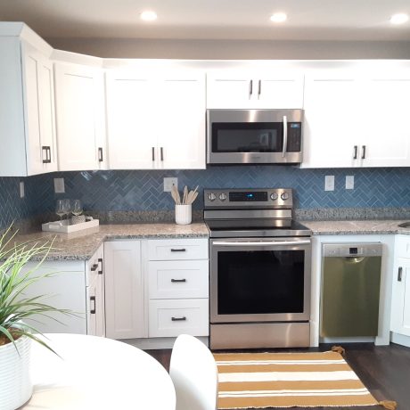 Blue ceramic tile herringbone pattern backsplash