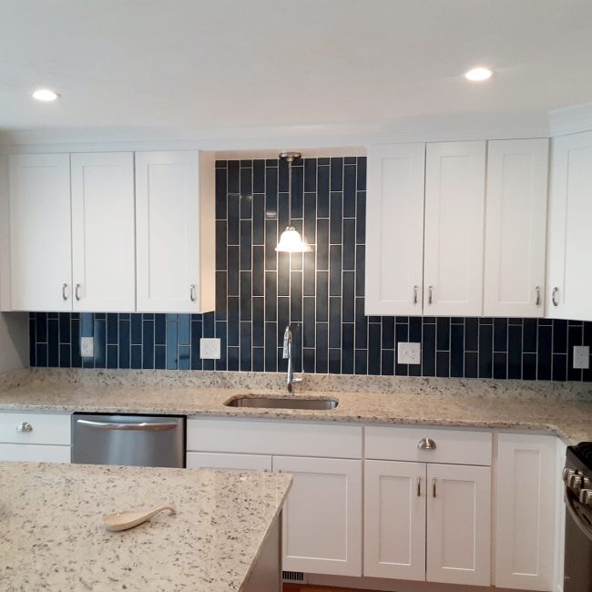 Dark blue kitchen tile backsplash Dark blue kitchen tile backsplash going up to the ceiling