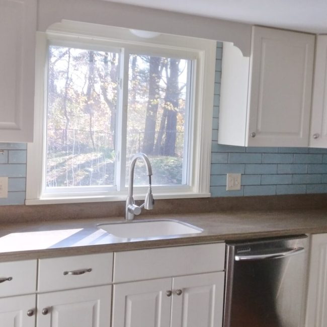 Large Blue Brick Style Tile Backsplash Large blue brick backsplash tile in a modern kitchen with a bold, clean design