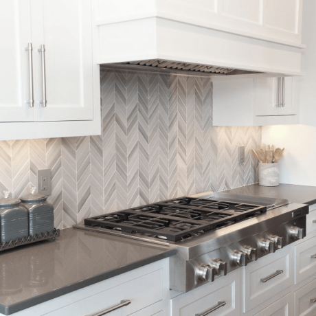 Chevron pattern backsplash with marble tile
