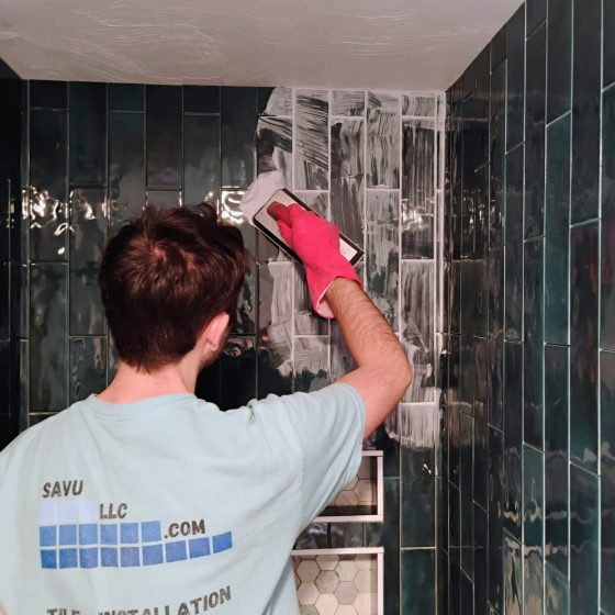 SAVU LLC tile installers grouting a tiled bathroom Grouting a green tiled bathroom