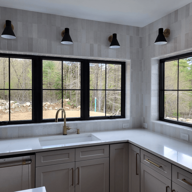 Vertical Gray Ceramic Backsplash in Soldier Stack Vertical gray ceramic backsplash in a straight soldier stack pattern behind a modern kitchen setup